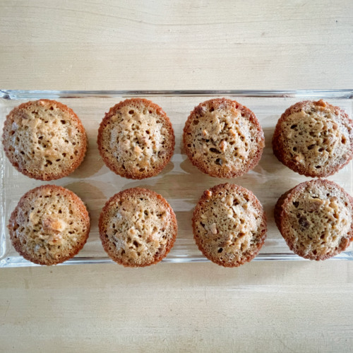 fresh baked pecan muffins on glass tray and wooden countertop