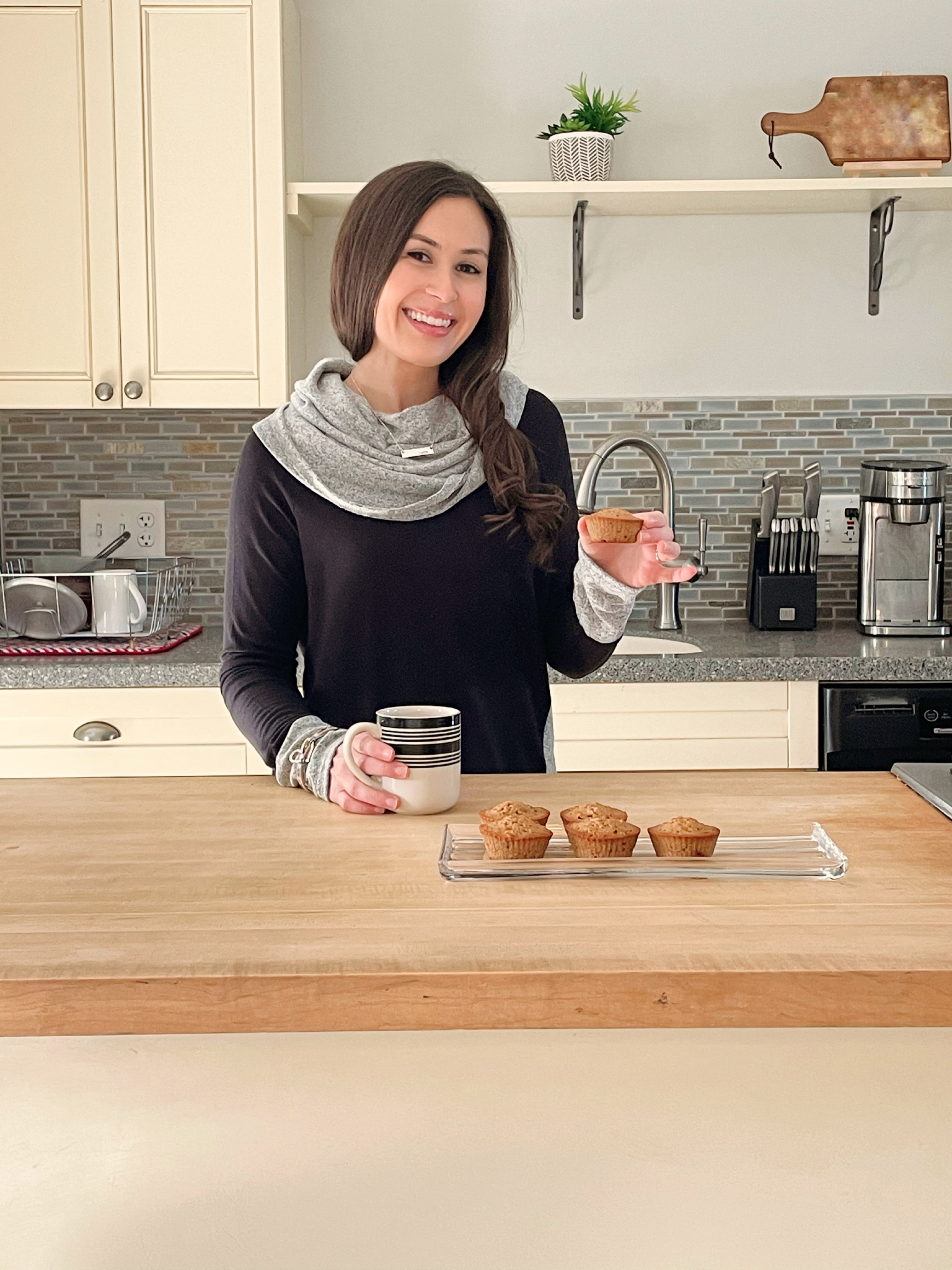 young woman baking muffins in kitchen with wooden butcher block countertops