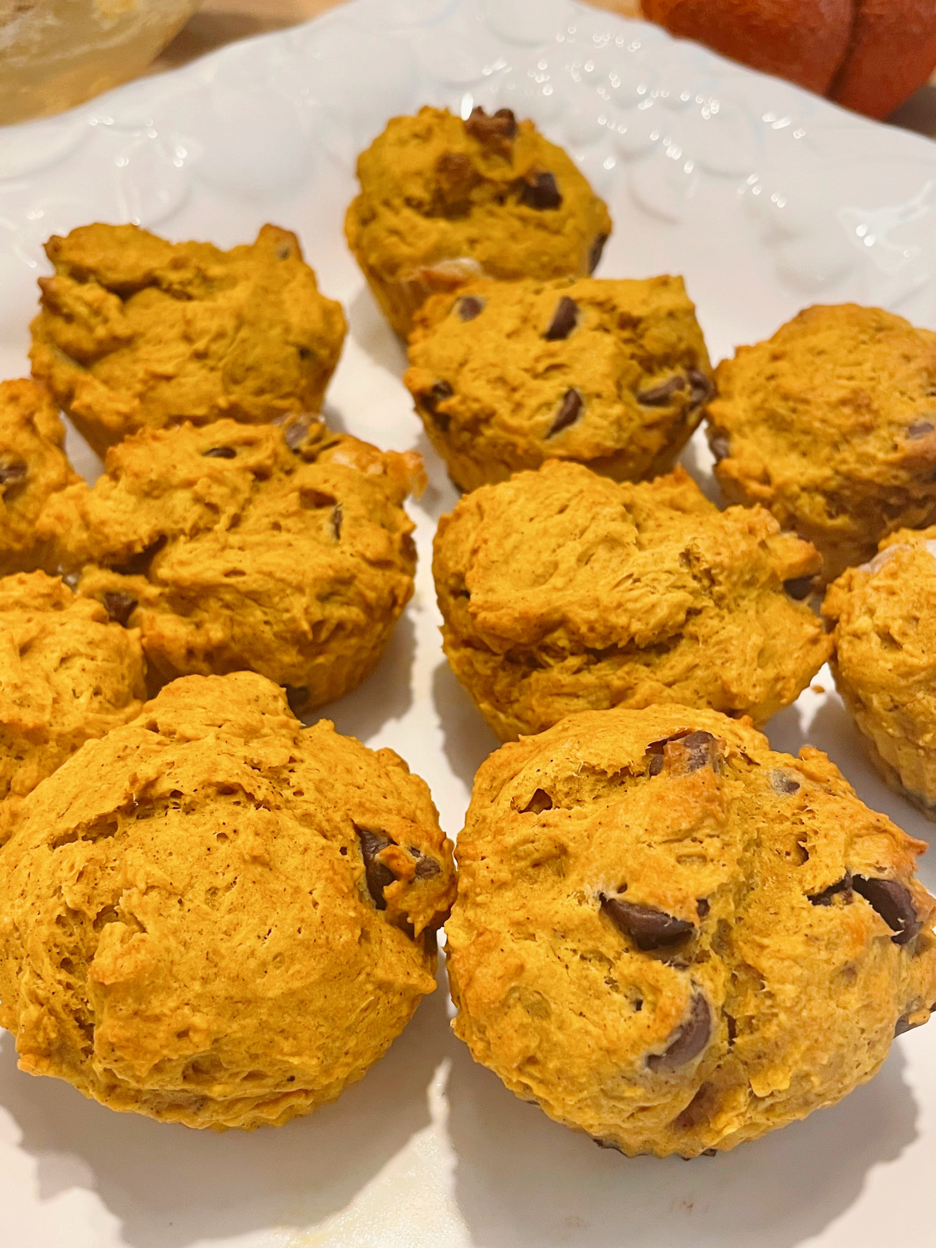 pumpkin chocolate chip muffins on white platter